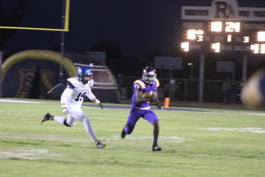 Zion Hall runs with the ball against Frontier player during a home game.