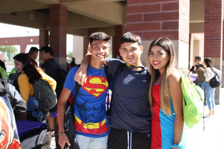 Three+friends+smile+for+the+picture+dressed+as+Superman+and+Wonder+Woman.+