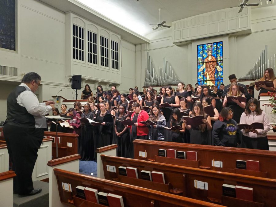 Ridgeview choir students gathering at a church to practice the song they will be performing with director of the Master Chorale, Robert Provencio. 