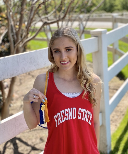 Senior, Taylor Jones poses with her FFA cord along with her Fresno State gear.