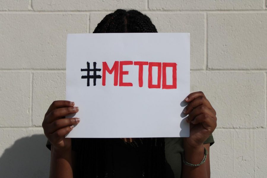 A person holds a Me Too sign which has gained  attention in the media.