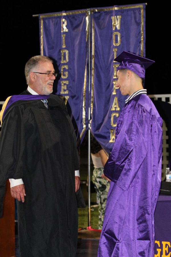 Principal Steve Holmes  with student during a graduation ceremony during his time at RHS. 