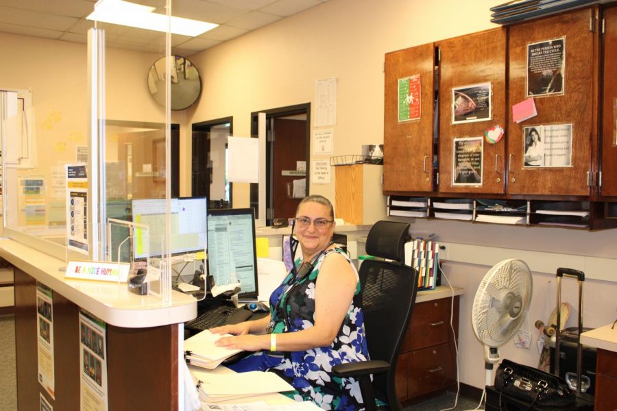 Ghada Akroush sits at her desk in the Deans office. 