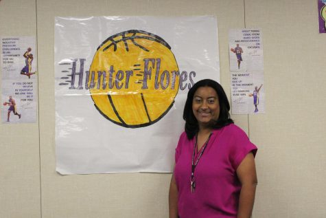 Ms. Hunter-Flores is standing in her classroom by her handmade nametag.