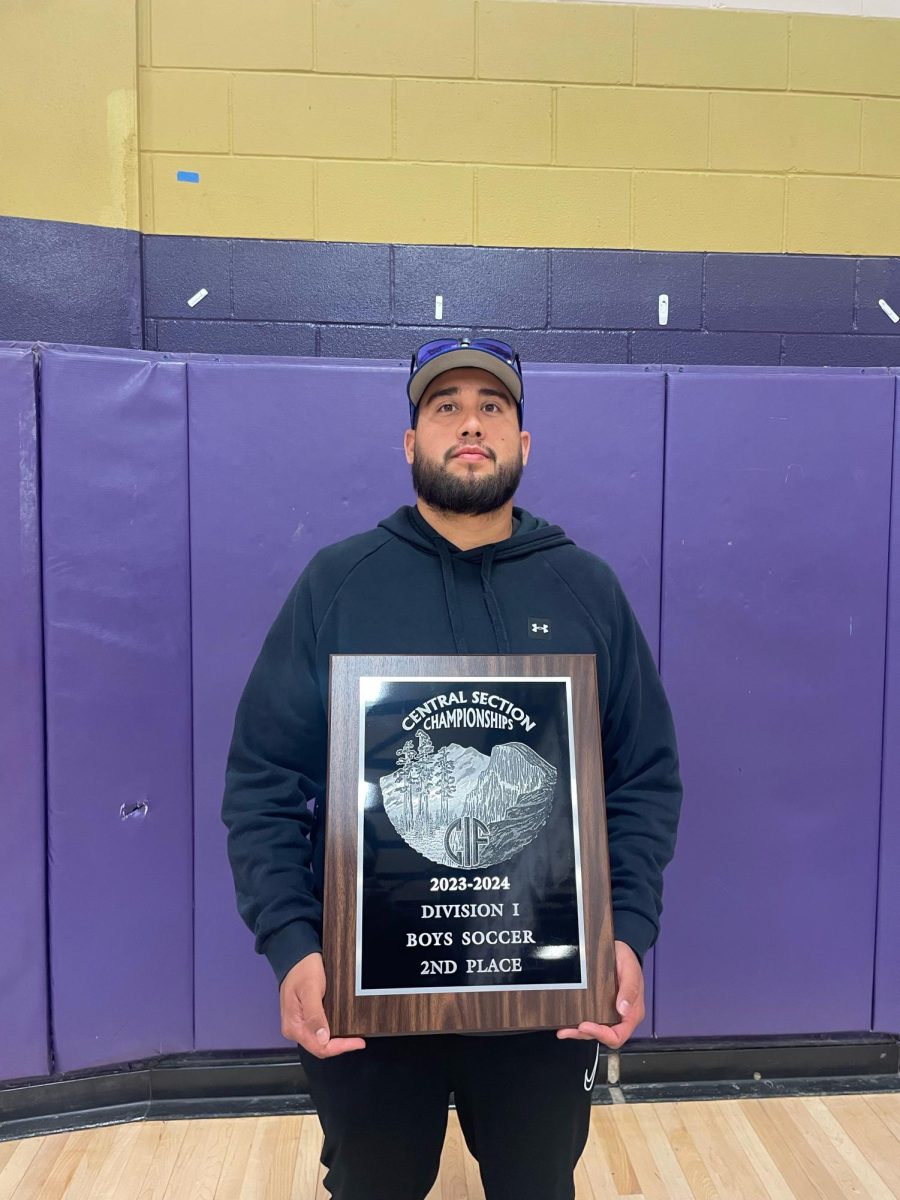 Coach Isai Cruz hold the Central Section plaque.
