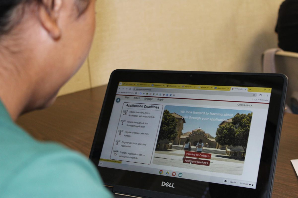 Student researching her college application deadlines. 