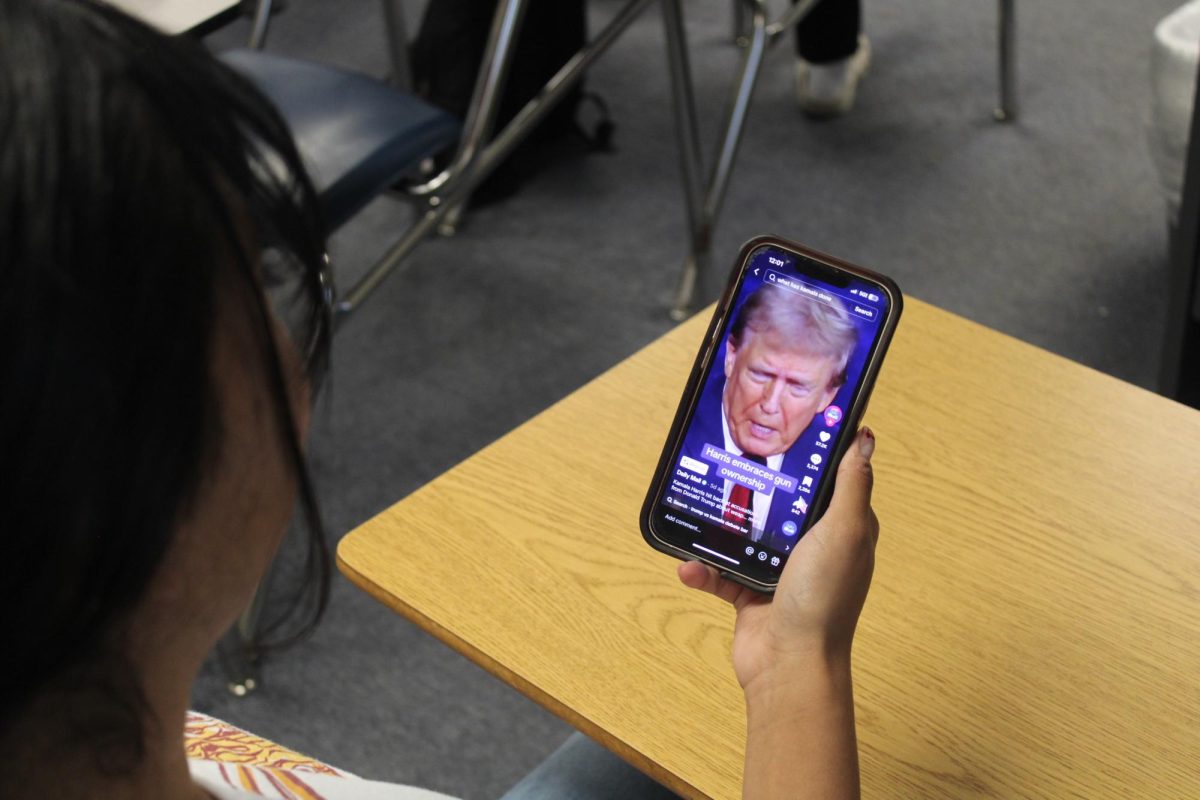 Student watching a TikTok about the recent debate with Donald Trump.