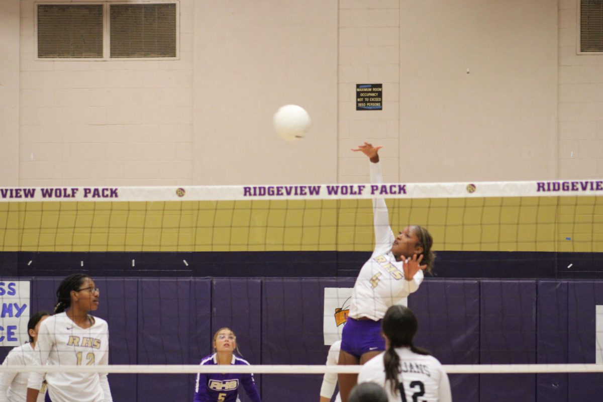 Outside hitter Jadah Tyler spikes a ball in a game against Foothill High. 