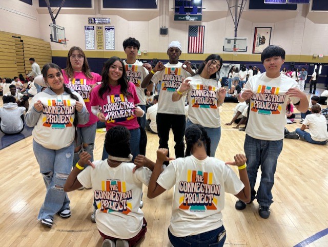 A group of students showing off their Connection Project shirts.