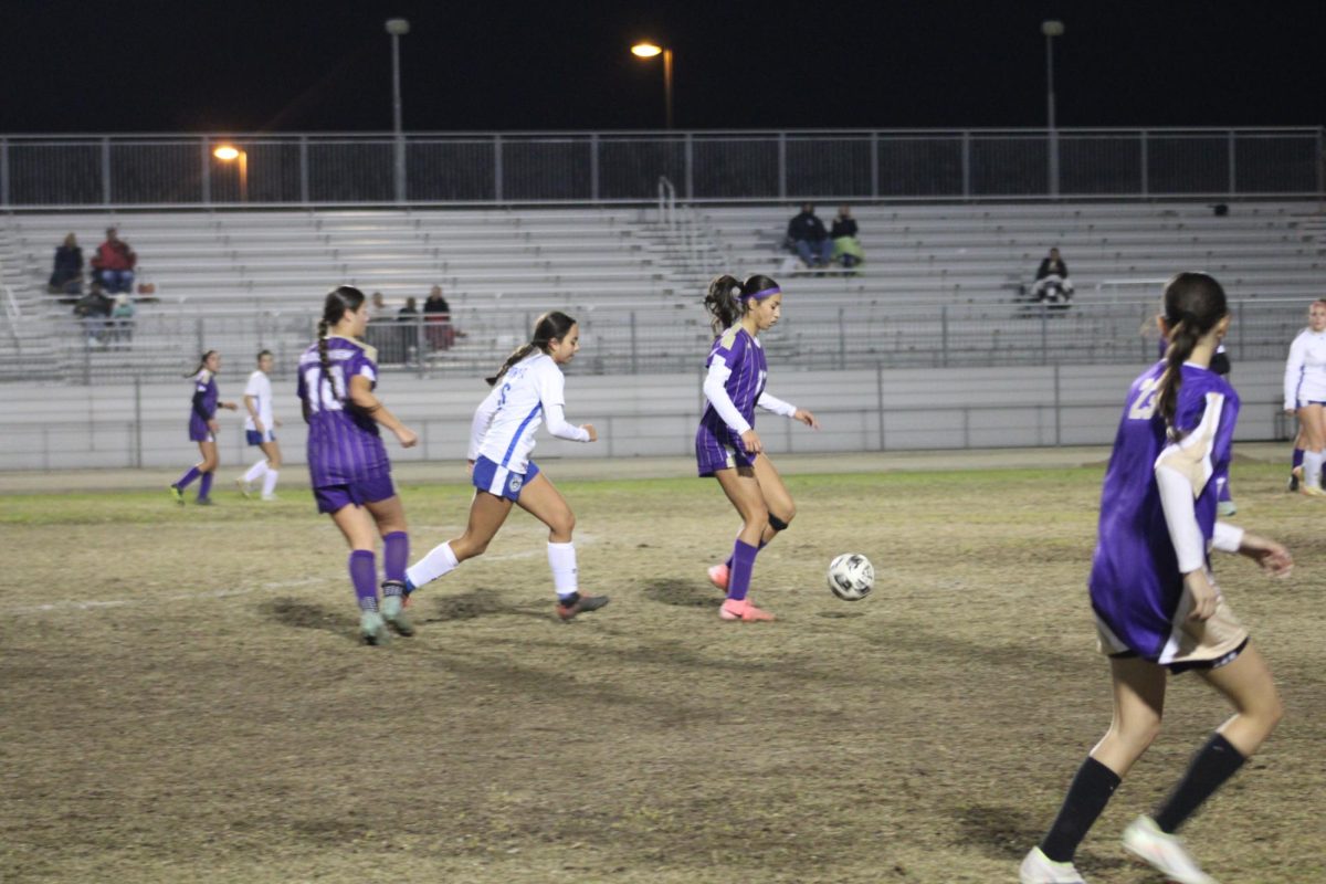 Ridgeview girls' soccer player kicking the ball.