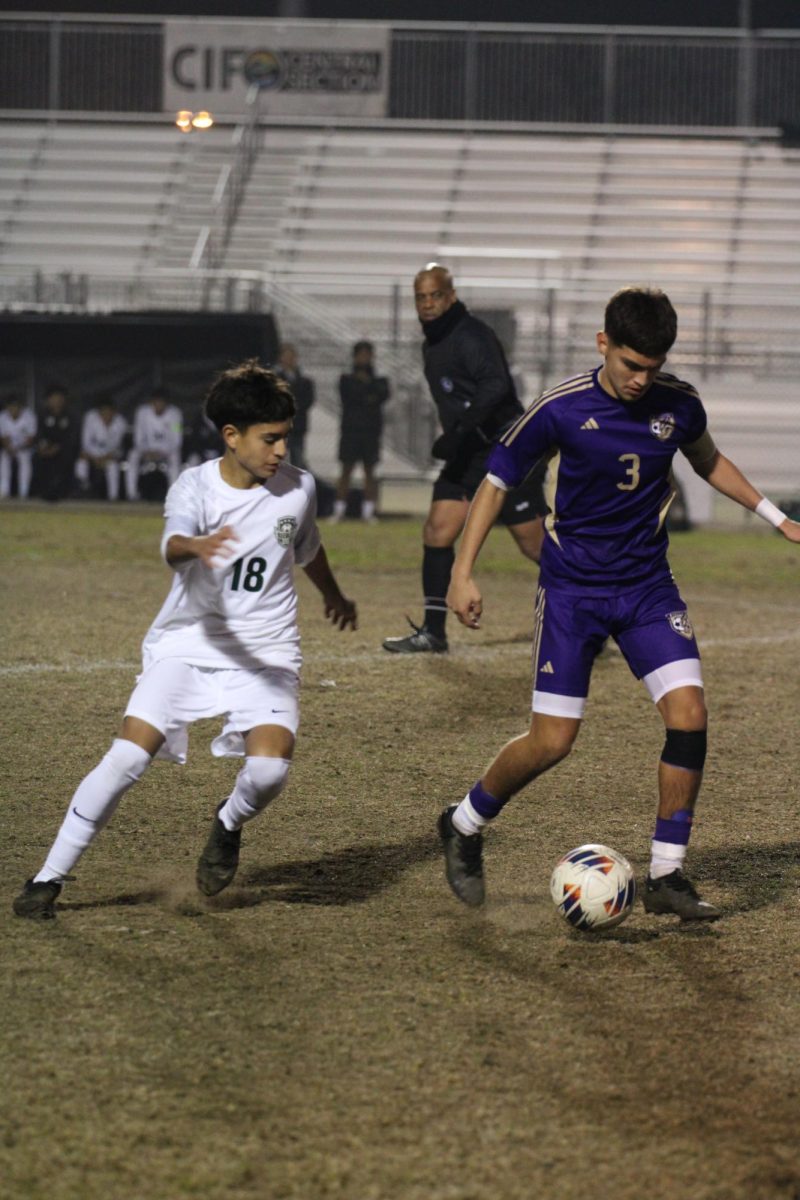 Andrew Nava dribbling the ball down field against Reedly.  