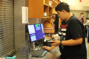 Reymundo Marquez working in the student store