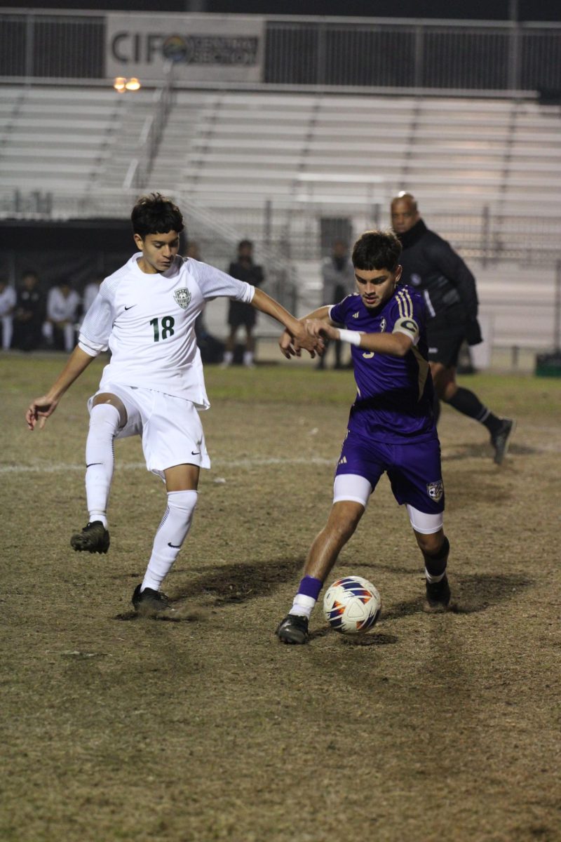 Andrew Nava fighting for the ball against his opponent Reedley Highschool