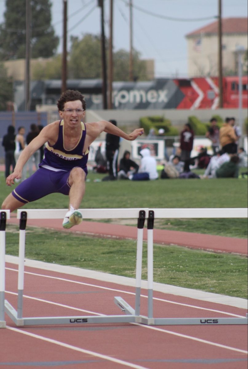 Landon Torres jumping over hurdles at his recent track meet