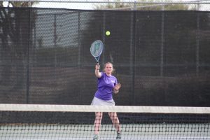 Emma Haycock hitting the ball across the court