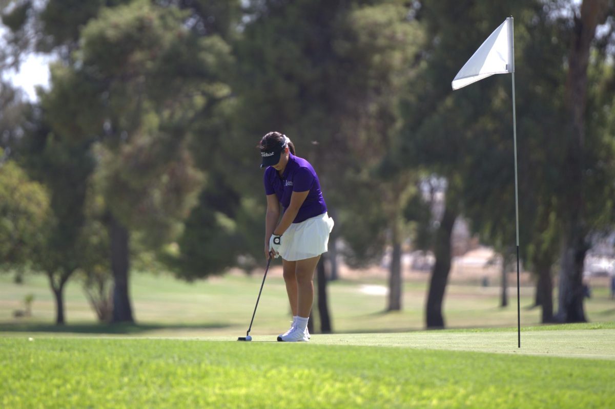 Mellisa Ruiz lining up the club to hit the golf ball
