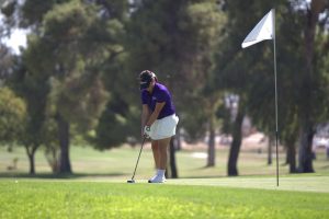 Mellisa Ruiz lining up the club to hit the golf ball