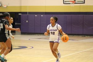 Akasia Jackson taking the ball down the court